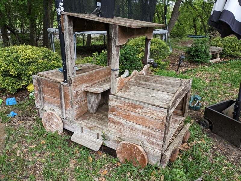 A wooden train-shaped playhouse from the kids' childhood