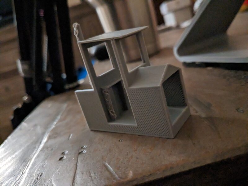 A miniature 3D printed replica of the train-shaped playhouse