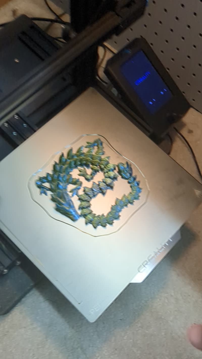 Video still of a 3D printed dragon being removed from the print bed