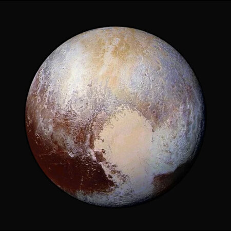 Pluto in enhanced color, imaged by the New Horizons spacecraft, showing its heart-shaped Tombaugh Regio