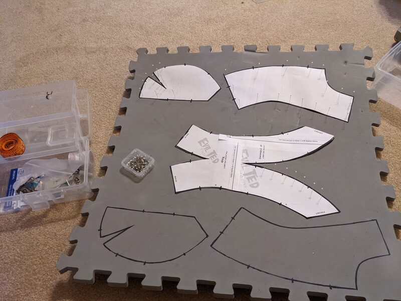 Paper paladin helmet patterns pinned onto EVA foam mats, ready to be traced and cut