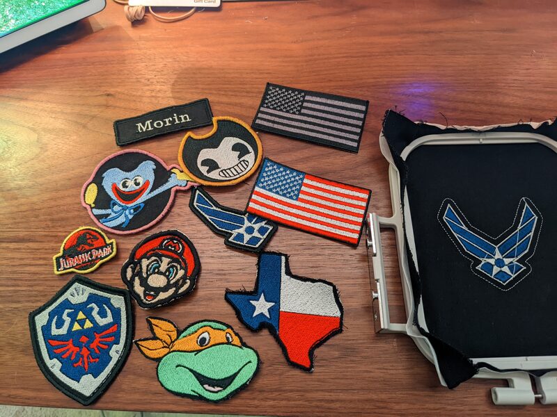 A flat-lay of about ten finished embroidered patches on a desk