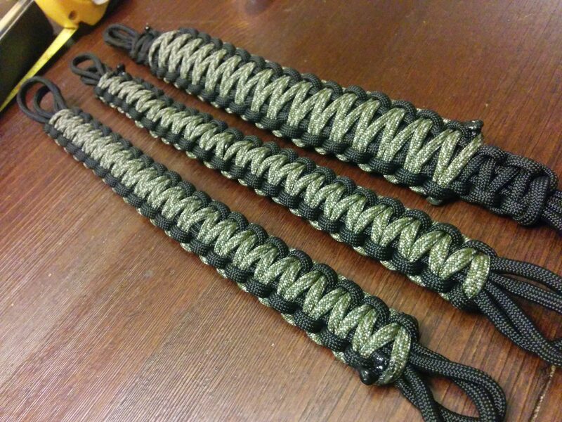 Two finished paracord-woven Jeep grab handles