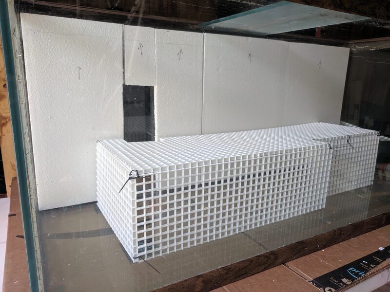 Foam insulation board lining the tank walls, with a plastic egg-crate platform zip-tied together inside to raise a false bottom